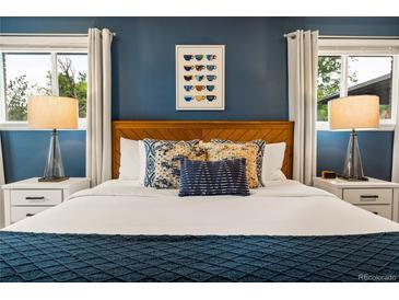 Comfortable bedroom featuring wood headboard, accent pillows, and matching bedside lamps at 7256 S Broadway, Centennial, CO 80122