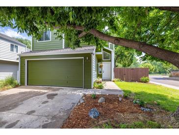 Charming home featuring an attached garage, verdant lawn, and inviting front entrance at 4129 Amber St, Boulder, CO 80304