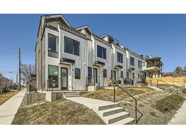 Modern townhomes with white siding, black trim, and small front yards offer contemporary living in a vibrant community at 1301 Osceola St, Denver, CO 80204