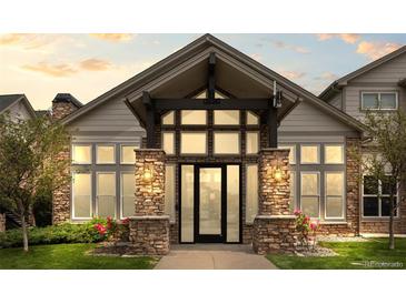 Elegant building entrance with stone pillars, ample windows, and craftsman style architectural elements at 7212 S Blackhawk St # 1-103, Englewood, CO 80112