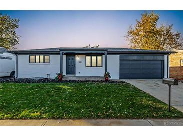 Newly renovated ranch home with modern exterior and landscaped lawn at 5519 Troy St, Denver, CO 80239