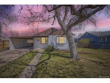 Charming single-story home with a covered parking area and a mature tree in the front yard at 1280 S Quitman St, Denver, CO 80219