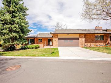 Charming single-story brick home with a two-car garage and well-maintained front lawn and mature trees at 2615 Oak Dr # 5, Lakewood, CO 80215