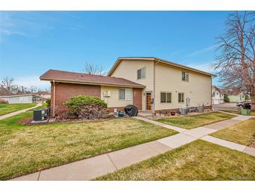 Charming home featuring well-maintained landscaping and a combination of brick and vinyl siding at 3355 S Flower St # 107, Lakewood, CO 80227