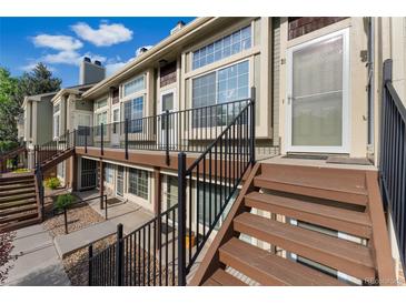 Inviting two-story townhouse featuring stairs, updated deck, and ample natural light at 1885 S Quebec Way # A28, Denver, CO 80231