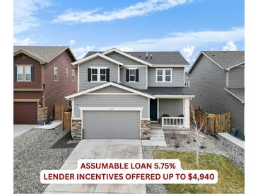 Charming two-story home boasts a gray facade, a well-manicured lawn, and a spacious two-car garage at 27674 E 7Th Dr, Aurora, CO 80018
