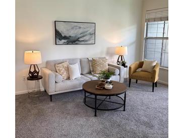 Cozy living room with neutral tones, stylish decor, and ample natural light from the nearby window at 7489 S Quail Cir # 814, Littleton, CO 80127