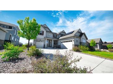 Beautiful home featuring a three-car garage, well-manicured lawn, solar panels and a long driveway at 8867 S Zante St, Aurora, CO 80016