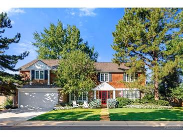 Beautiful two-story home with red door, landscaping, and a spacious yard at 7205 S Newport Way, Centennial, CO 80112