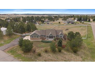 Charming single-Gathering home with neutral siding, mature trees, a covered front porch, and plenty of curb appeal at 3342 Quail Ridge Cir, Parker, CO 80138
