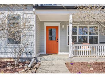Charming front entrance with a vibrant orange door and covered porch, creating a welcoming curb appeal at 1495 Zamia Ave # 3, Boulder, CO 80304