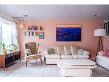 Inviting living room with comfortable seating, decorative shelves, and stylish decor at 2557 S Dover St # 85, Lakewood, CO 80227
