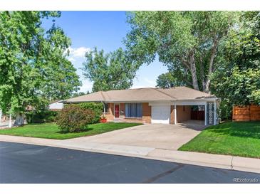 Charming single-story home with a well-maintained front yard, driveway, and attached garage at 420 Dudley St, Lakewood, CO 80226
