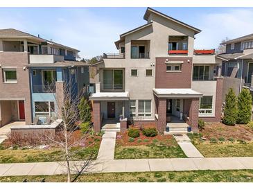 Beautiful, modern townhome featuring gray stucco and brick, plus balconies and landscaped front yards at 4535 W 50Th Ave, Denver, CO 80212