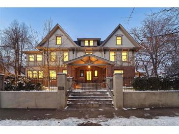 Stunning brick home with a grand facade, inviting porch, and charming landscaping at 1433 E 7Th Ave, Denver, CO 80218