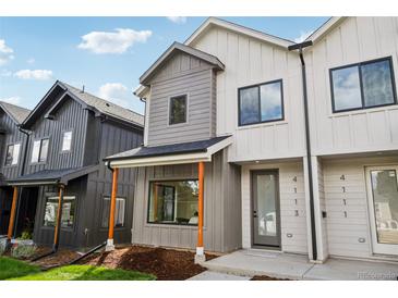 Modern townhome featuring mixed siding, a covered entry, and sleek black window frames at 4101 S Lincoln St, Englewood, CO 80113