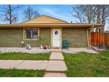 Charming single-story home with a welcoming front porch and well-maintained landscaping at 12458 E Kansas Pl, Aurora, CO 80012