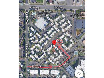 An aerial view shows the Woodstream Falls Condominiums with parking and a path leading to Sage at Panorama at 9725 E Harvard Ave # 305, Denver, CO 80231