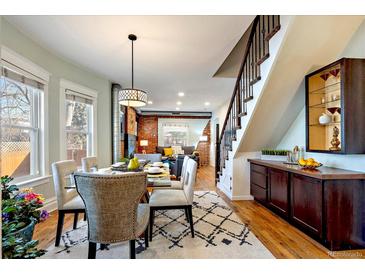 Bright dining area adjacent to the living room with staircase and dining table at 3233 W 29Th Ave, Denver, CO 80211