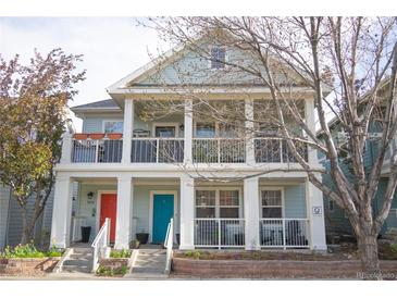 Charming two-story home featuring inviting front porches and colorful doors at 7472 E 28Th Ave, Denver, CO 80238