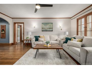 Bright living room featuring hardwood floors, a ceiling fan, and neutral décor with light-filled space at 1138 E 14Th Ave # 12, Denver, CO 80218