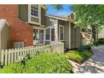 Charming townhouse with a well-kept front yard and a white picket fence at 2013 S Helena St # B, Aurora, CO 80013