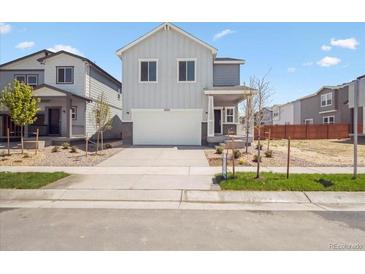 Charming two-story home featuring a neutral color palette and an attached two-car garage at 2222 Flower Blossom Ave, Brighton, CO 80601