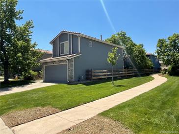 Charming home with a landscaped yard, attached garage, and inviting curb appeal at 21300 E 42Nd Ave, Denver, CO 80249