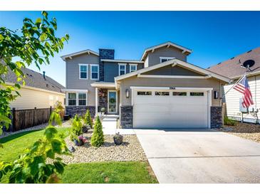 Charming two-story home with a well-manicured lawn, stone accents, and an attached two-car garage at 3966 Long Rifle Dr, Castle Rock, CO 80108