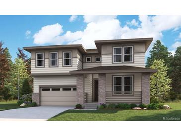 A modern two-story home boasts large windows and a neutral color palette, complemented by professional landscaping at 2645 Mondt Ln, Erie, CO 80026