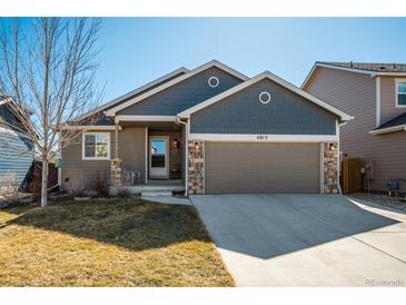 Charming single-Gathering home featuring a two-car garage and inviting front porch at 6812 Indian Paintbrush St, Frederick, CO 80530