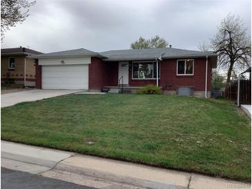 Charming single-story brick home featuring an attached garage and well-maintained front lawn at 1152 S Eaton St, Lakewood, CO 80232