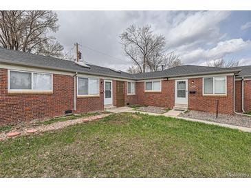 Brick exterior of a multi-Gathering home with well-maintained landscaping in a residential neighborhood at 1533 Xenia St, Denver, CO 80220