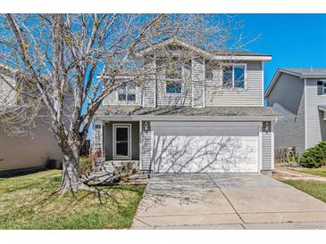 Charming two-story home with a well-manicured lawn, mature tree and a two car garage at 9508 Elk Mountain Cir, Littleton, CO 80125