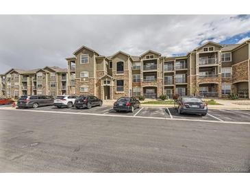 Charming condo complex featuring beautiful stonework and convenient parking at 1465 Blue Sky Cir # 17-203, Erie, CO 80516