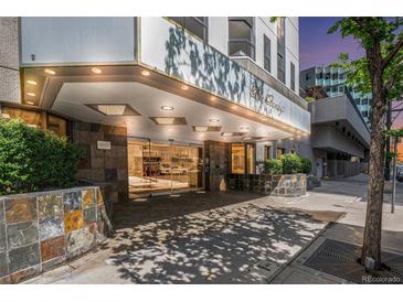 Apartment building entrance with automatic glass doors and stone accents at 1625 Larimer St # 1001, Denver, CO 80202