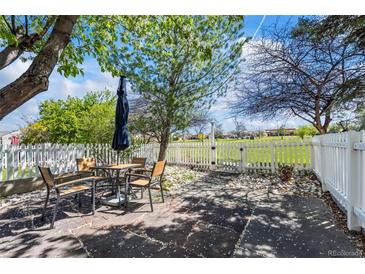 Inviting back patio with a table and chairs, perfect for outdoor dining and relaxation at 3076 W 112Th Ct # C, Westminster, CO 80031