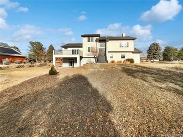 Stunning two-story home featuring a modern design and private balcony perfect for outdoor relaxation at 6400 N Windfield Ave, Parker, CO 80134