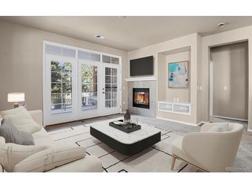 Bright living room features a fireplace, balcony access and modern neutral finishes at 2210 S Vaughn Way # 103, Aurora, CO 80014