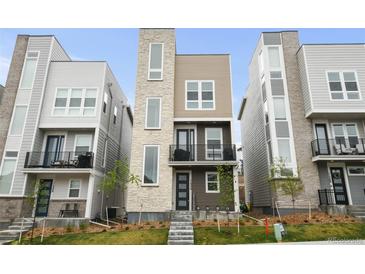 Striking modern home featuring mixed materials, a balcony, and well-maintained landscaping at 11350 W Grand Ave, Littleton, CO 80127
