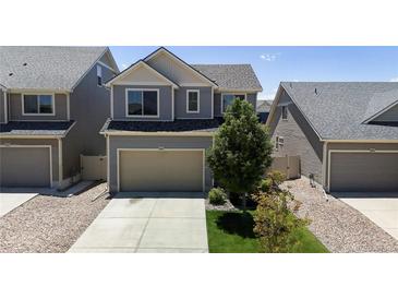 Charming two-story home with a two car garage, landscaped yard, and neutral siding at 19000 E 55Th Ave, Denver, CO 80249