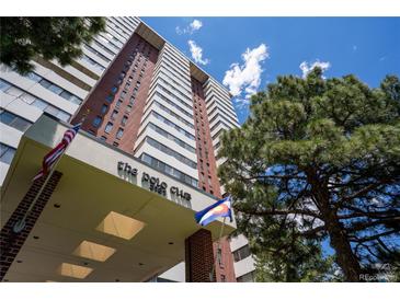 High-rise condominium building featuring brick and white facade under a sunny sky and mature trees at 3131 E Alameda Ave # 1604, Denver, CO 80209