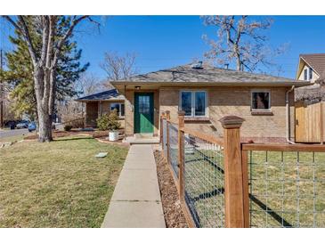 Charming brick home with a well-maintained lawn, walkway, and a decorative wire fence at 2001 Grove St, Denver, CO 80211
