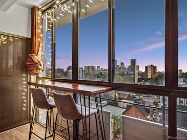 Cozy balcony featuring a wooden counter, bar stools, and stunning city views at 800 N Pearl St # 709, Denver, CO 80203