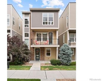 Charming three-story townhome with stone accents, balcony, and well-maintained landscaping at 524 E Hinsdale Ave, Littleton, CO 80122