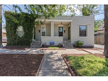 Charming duplex featuring beautiful brickwork and lovely landscaping at 914 E Iowa Ave, Denver, CO 80210