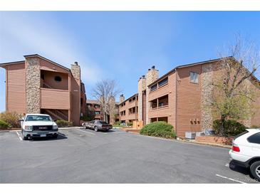 Inviting condo community showcasing well-maintained buildings, assigned parking, and attractive landscaping against a clear blue sky at 4681 S Decatur St # 227, Englewood, CO 80110