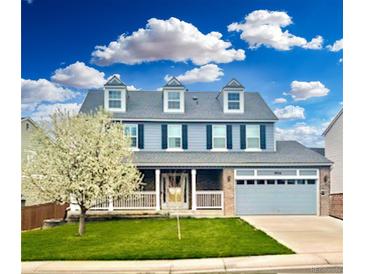 Charming two-story home with a landscaped front yard and a two-car attached garage at 9954 Heywood St, Highlands Ranch, CO 80130