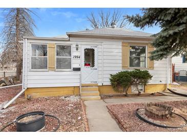Charming single-story home featuring a well-maintained front yard with mature landscaping and a cozy entrance at 1994 Macon St, Aurora, CO 80010