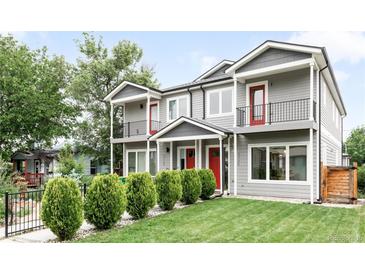 Charming home featuring gray siding, red doors, black metal railings, and well-maintained landscaping at 4730 S Acoma St, Englewood, CO 80110